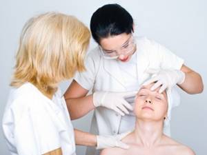 dermatologist examining facial zones